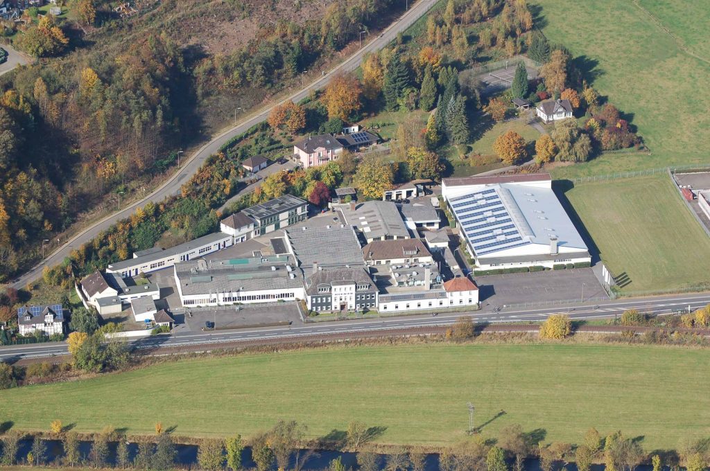 The picture is an aerial view of the site of DIENES Werke GmbH & Co. KG, Overath.